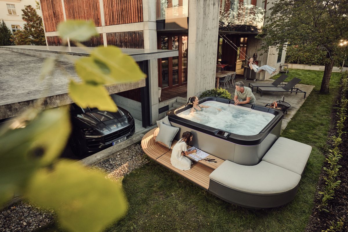 A family enjoying the SP—116 spa in the garden of a modern house