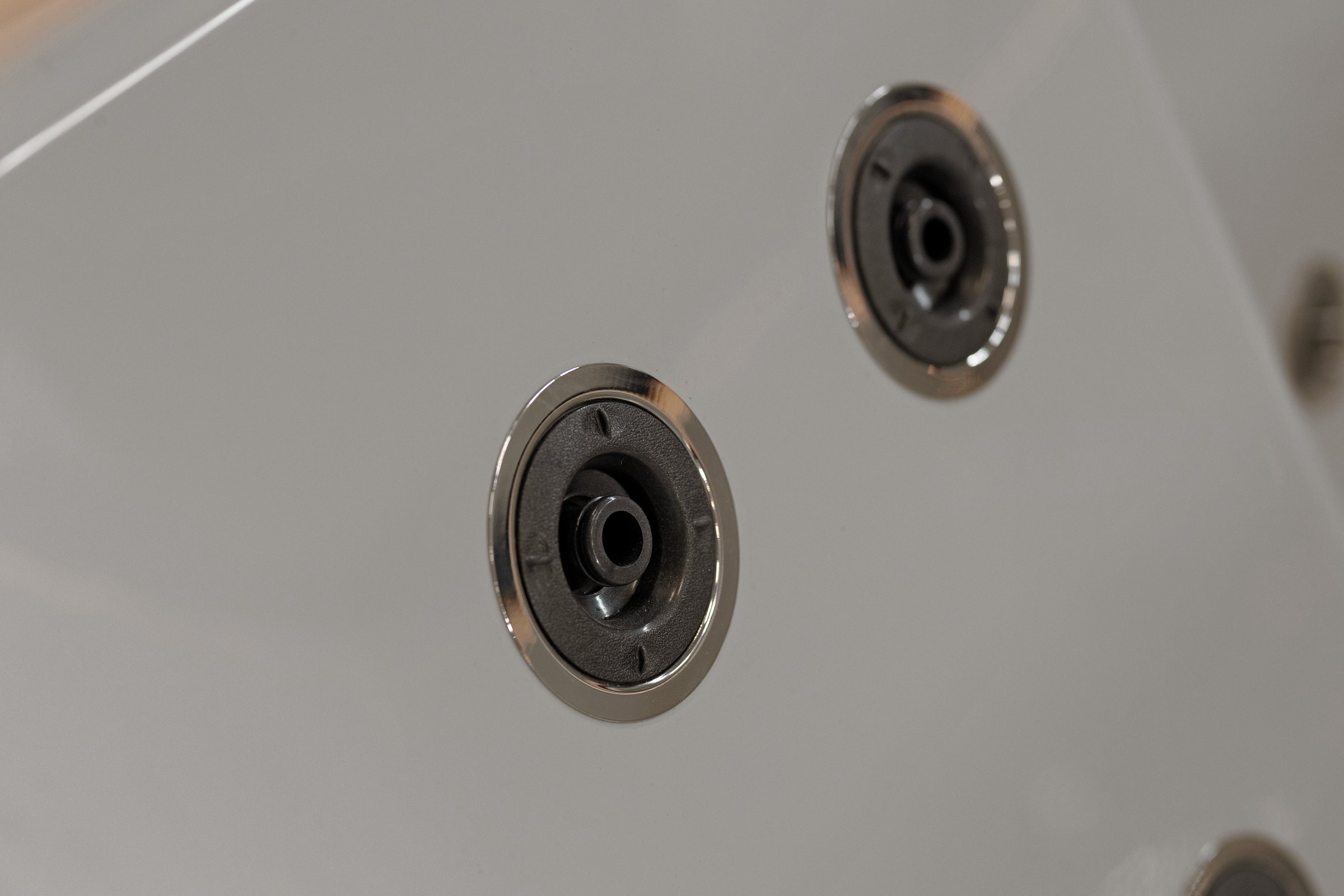 Close-up of the hydromassage jets with polished trim rings